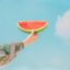 person holding sliced watermelon